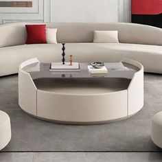 a modern living room with white furniture and red pillows on the couches in it