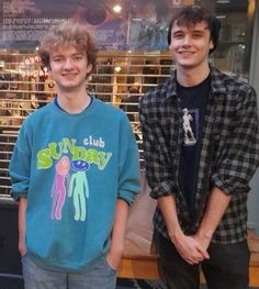 two young men standing next to each other