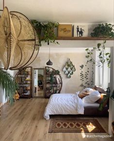 a bedroom with wooden floors and plants on the wall