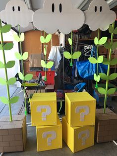 some cardboard boxes are sitting on the floor with plants growing out of them and question marks