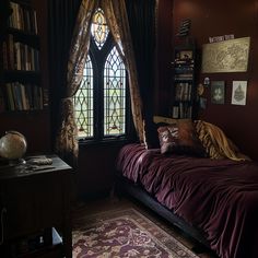 a bed sitting in front of a window next to a book shelf filled with books