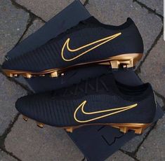 two black and gold nike soccer cleats