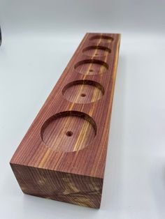 a wooden object with holes in it on a table