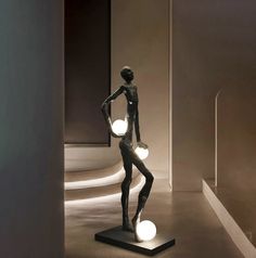 a statue is shown with two lights in it's hands and one light on the ground