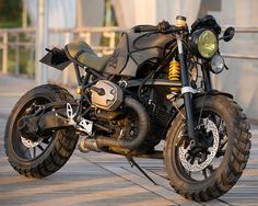 a motorcycle parked on the side of a bridge