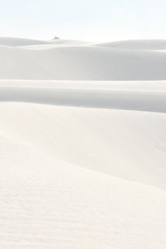 two people walking in the snow with skis