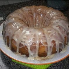 a bundt cake with icing sitting on a plate