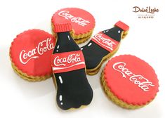 coca - cola cookies are decorated with royal icing and black frosting, along with two coke bottle caps