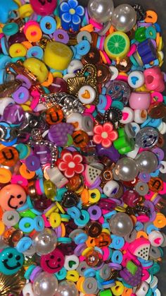 there are many different types of buttons in the bins on the table, and one is full of them