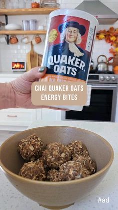 a person holding up a container of energy bites in front of a bowl filled with oatmeal