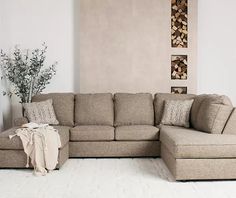 a living room with a sectional couch and pillows