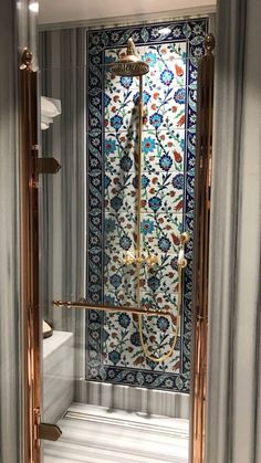 an ornate shower in the corner of a room