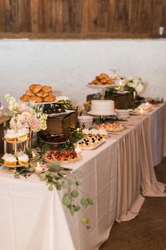 a table topped with lots of cakes and desserts