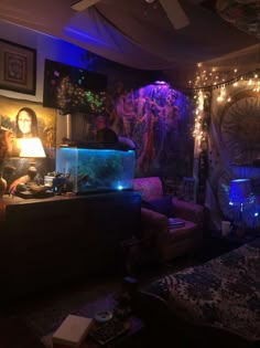 a living room filled with lots of furniture and lights on the ceiling, along with a fish tank