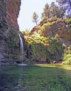 there is a small waterfall in the middle of this river and it's clear water