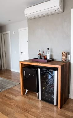 an air conditioner sitting on top of a wooden cabinet