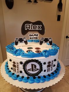 a cake that is sitting on top of a table in front of a wall with video game controllers