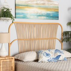 a bed with a wooden headboard next to a painting on the wall above it