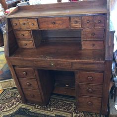 an old wooden desk with drawers on top