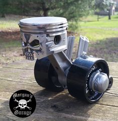 an image of a motorcycle engine on a wooden table in the day time with skull and crossbones