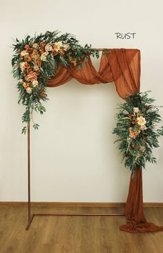 an arch decorated with flowers and greenery