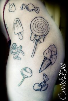 a woman's thigh with various candy tattoos on it