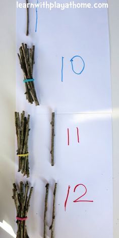 two pieces of paper with numbers on them and some sticks sticking out of the side