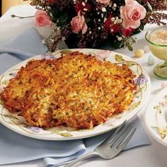 a table topped with a pie covered in toppings next to glasses and silverware