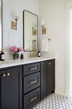 a bathroom with black cabinets and white tile