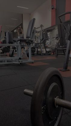 a gym filled with lots of machines and dumbbells