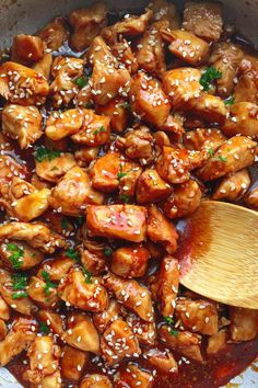 chicken with sesame seeds and sauce in a skillet