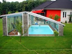 a house with a swimming pool in the middle of it's yard and an enclosed patio