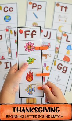 a person holding up some orange crayons to write the letter f for thanksgiving