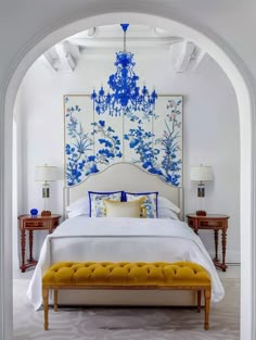 an archway leading to a bed with blue and white decorations on the wall above it