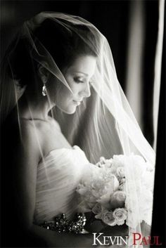 an image of a woman wearing a wedding dress and holding a bouquet in her hand