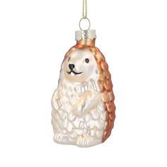 a glass ornament with a dog on it's side and a white background