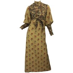 Beautiful 1970s Victorian inspired Autumnal lightweight wool challis long sleeve maxi dress ! Features warm tone of khaki, brown, red, burgundy, green and orange. Printed flowers and leaves throughout. High neck with bishop sleeves. Hidden zipper up the back with hook-and-eye closures. Buttons at each sleeve cuff. Tie belt at waist can be tied in the front or back. Fully lined. In great condition Approximately Size Medium Measurements: 34 inch bust 29 inch waist ( can be made smaller with attach Challis Dress, Silk Tank Dress, Long Halter Dress, High Neck Maxi Dress, 70s Maxi Dress, Fall Vintage, Seventies Fashion, Designer Evening Dresses, Warm Tone