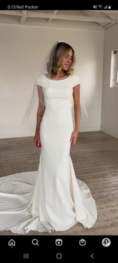 a woman in a white wedding dress posing for the camera