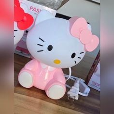 a hello kitty light sitting on top of a wooden table