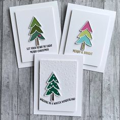 three cards with christmas trees on them, one is white and the other is green