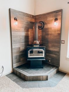 an old fashioned stove sits in the corner of a room with wood paneling on the walls