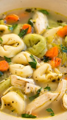 a white bowl filled with pasta and vegetable soup