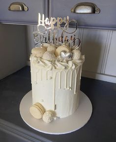 a birthday cake with white frosting and decorations