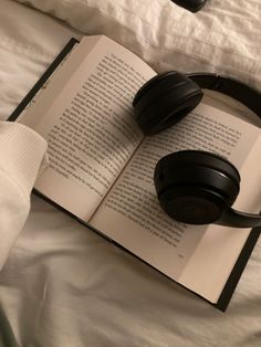 an open book with headphones on top of it