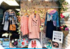 clothing and shoes are on display in a store window