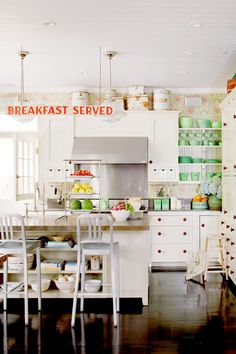 a kitchen filled with lots of white furniture