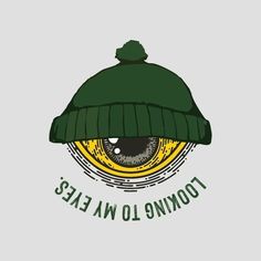 an eye wearing a green beanie with the words, toming low eaes