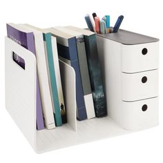 a white desk organizer with several books and binders