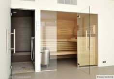 an indoor sauna is shown with glass doors