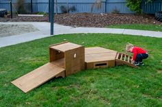 a little boy playing with some kind of wooden structure